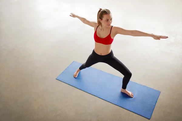 Above portrait of young yoga woman warrior pose. — Stock Photo, Image