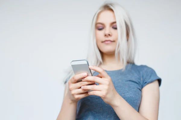 Mulher casual mensagens de texto em seu telefone — Fotografia de Stock