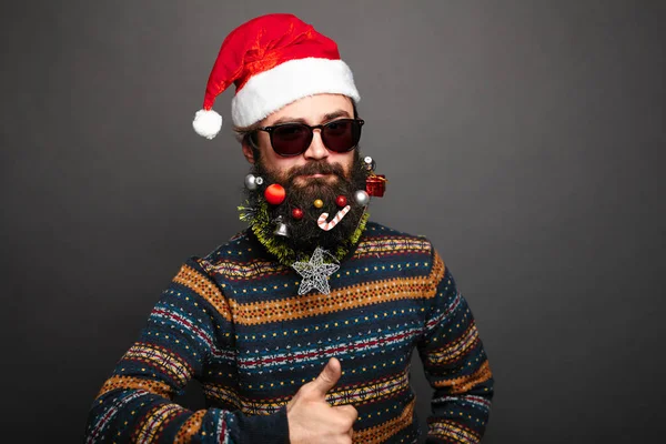 Bearded male in santa hat shows thumbs up. — Stock Photo, Image