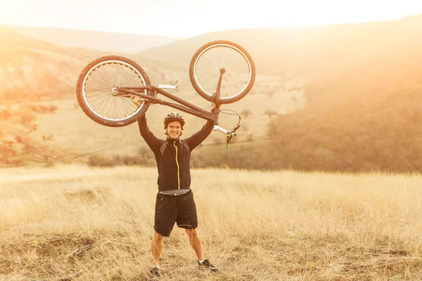 Cheerful man holding trial bike — Stock Photo, Image