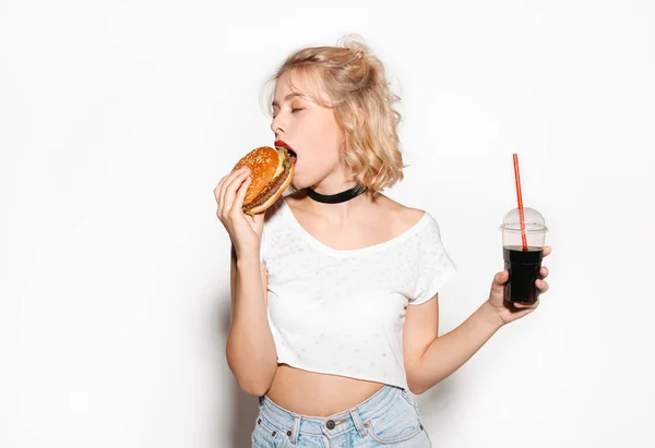 Slim trendy girl with hamburger and cola — Stock Photo, Image