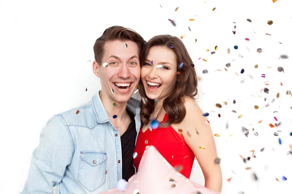 Couple embracing and confetti flying in air — Stock Photo, Image