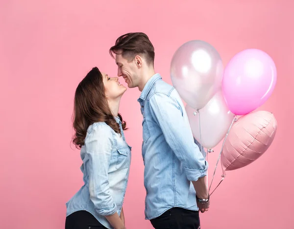 woman and man holding balloons