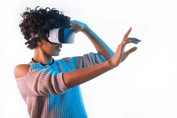 Pretty woman wearing VR goggles touching air — Stock Photo, Image