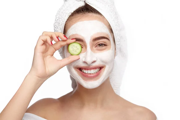 Woman closing eye with cucumber — Stock Photo, Image