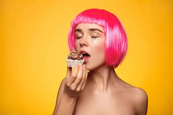 Attractive woman biting cupcake — Stock Photo, Image