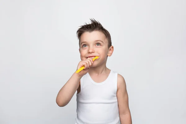 Small kid brushing teeth on white — Stock Photo, Image