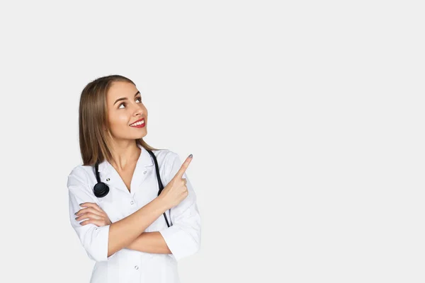 Young female doctor pointing up — Stock Photo, Image