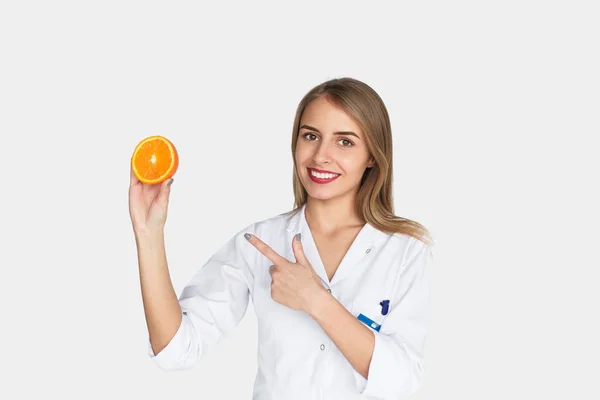 Cheerful doctor posing with orange — Stock Photo, Image