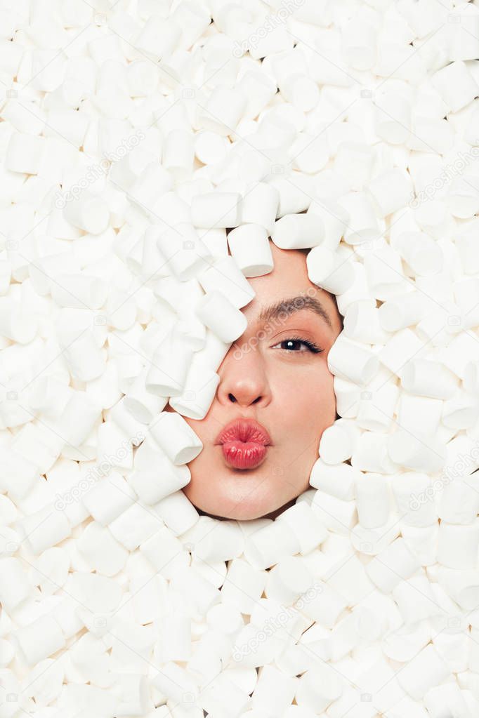 Woman grimacing in marshmallows