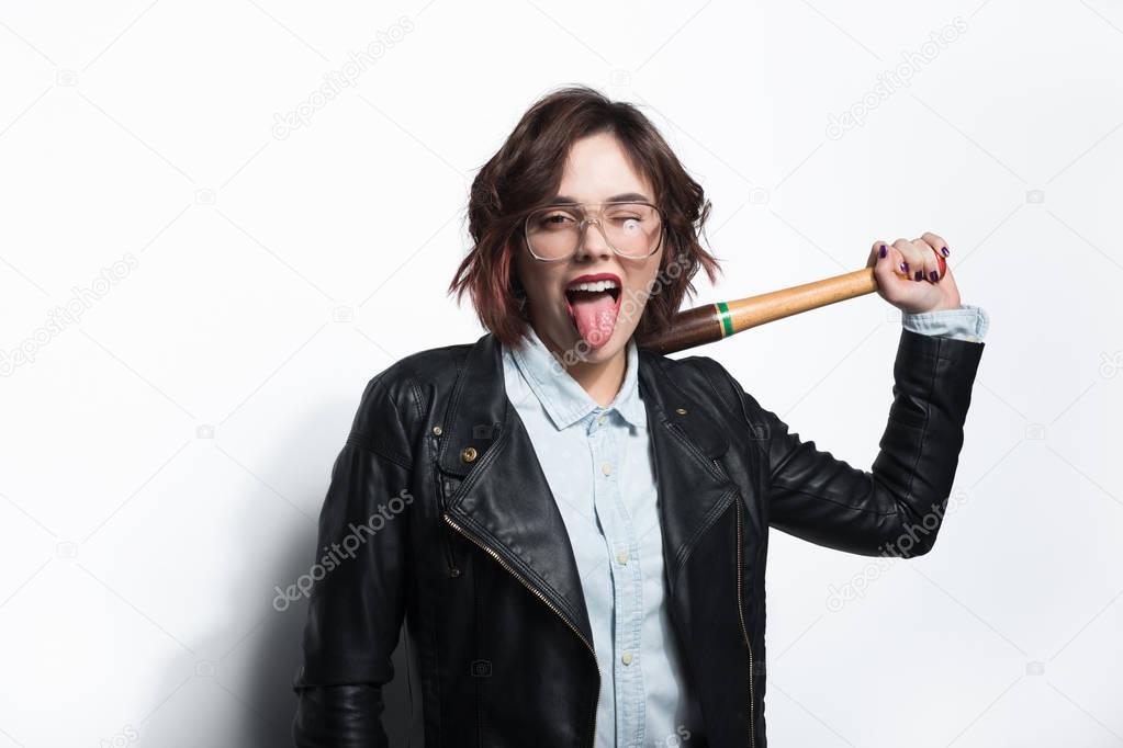 Woman with tongue out and bat