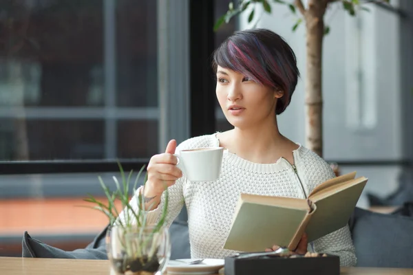 Giovane donna con libro e caffè — Foto Stock