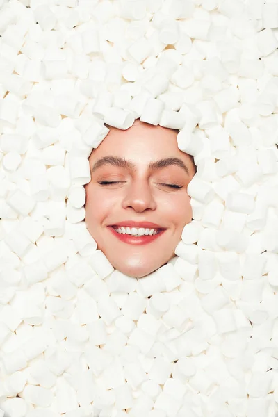 Content woman in marshmallows — Stock Photo, Image