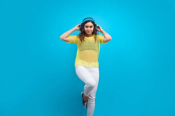 Girl wearing blue headphones — Stock Photo, Image