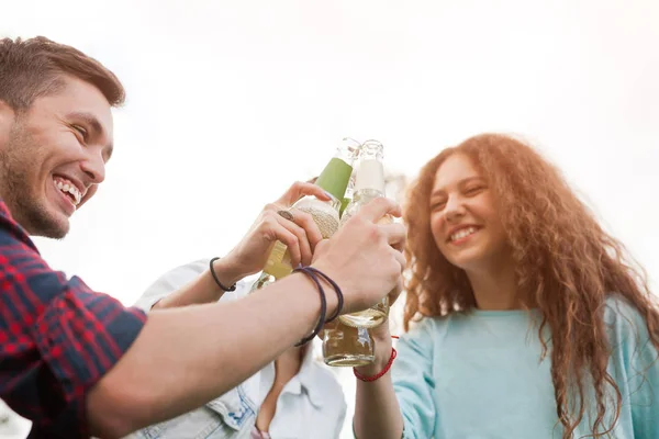 Friends having fun and clinking bottles — Stock Photo, Image