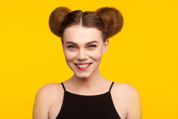Girl with two buns on head smiling — Stock Photo, Image