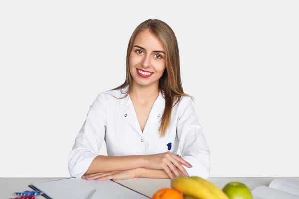 Smiling doctor posing at desktop — Stock Photo, Image