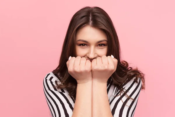 Woman holding fists up to mouth — Stock Photo, Image