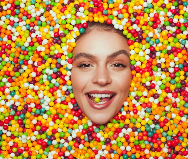 Woman with candy between teeth — Stock Photo, Image