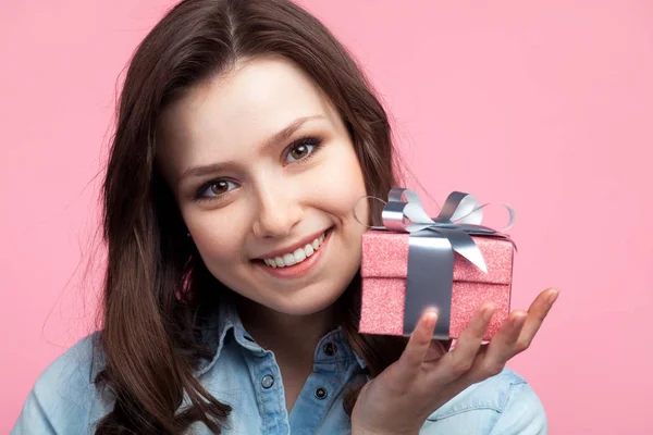 Girl in casual shirt holding small giftbox Stock Photo