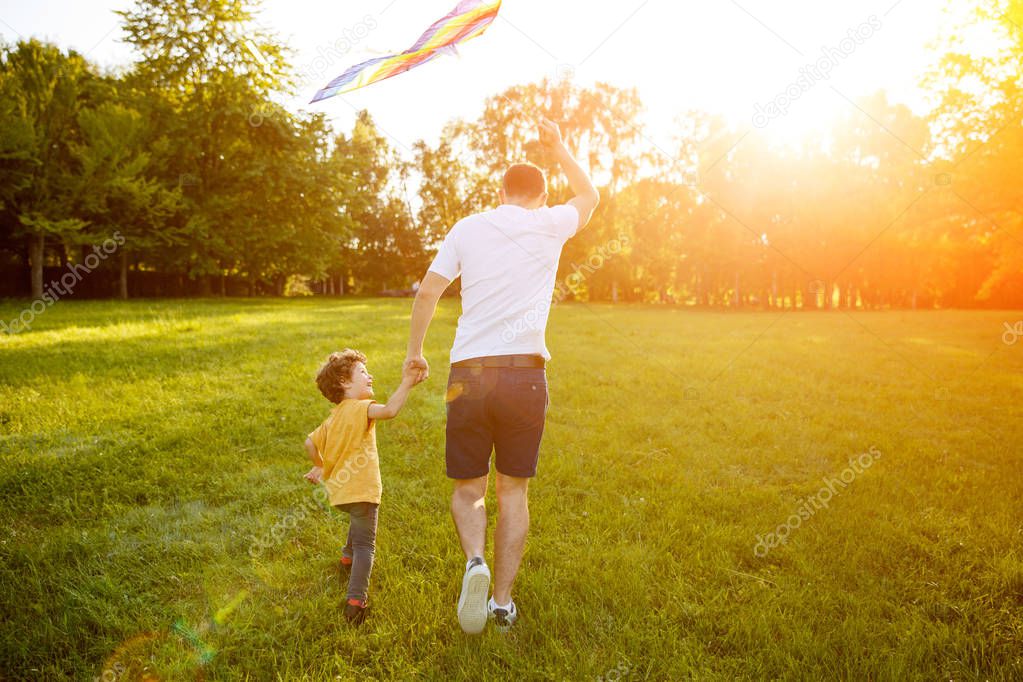 Father and sun holding hands running