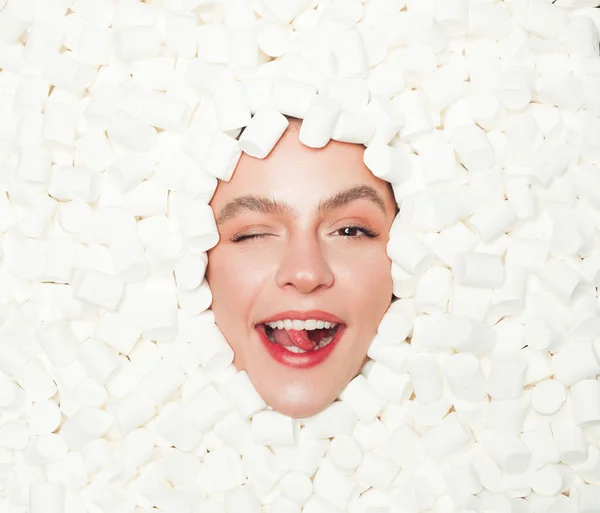 Winking model posing in mashmallow — Stock Photo, Image