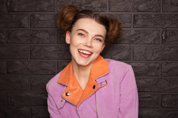 Woman with hair buns wearing pink jacket — Stock Photo, Image
