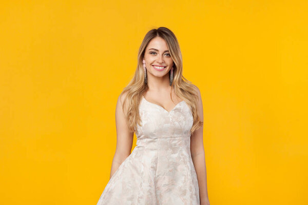 Lovely young woman wearing white dress