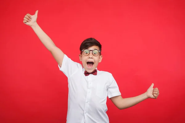 Cheerful boy gesturing on red — Stock Photo, Image