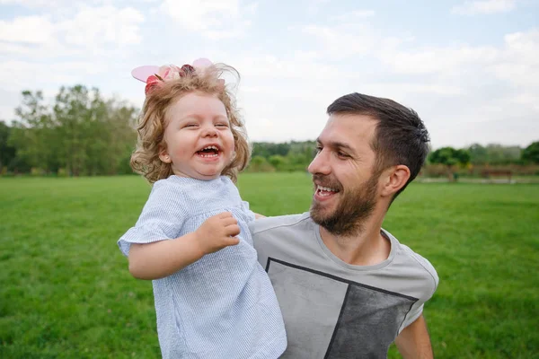 Alegre padre llevando sonriente hija en el parque —  Fotos de Stock