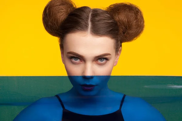 Girl with hair buns looking at camera — Stock Photo, Image