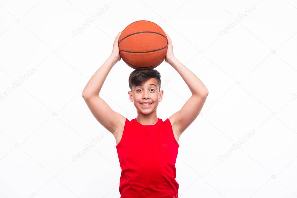 Smiling sportive kid with basketball