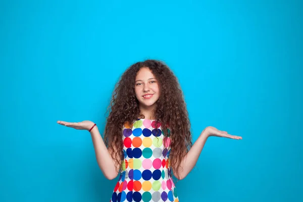 Curly haired girl holding hands palm up — Stock Photo, Image