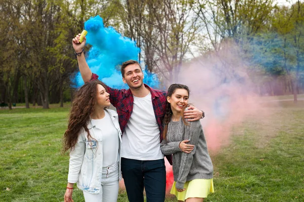 Guy with smoke flare and girls — Stock Photo, Image