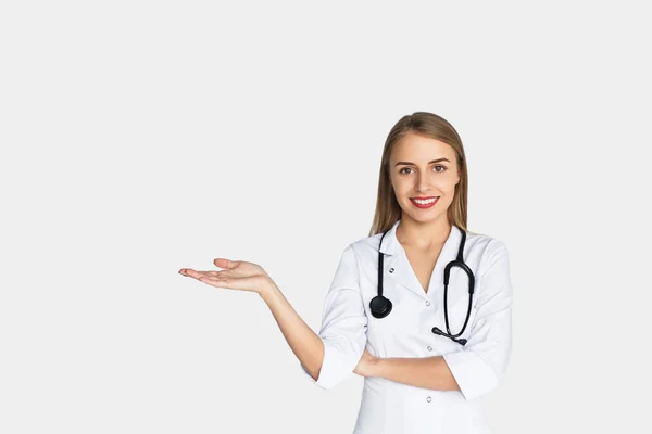 Woman in whites holding hand palm up — Stock Photo, Image