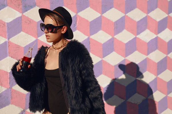 Stylish model posing with soda