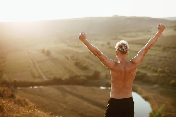 Fit man poserar på berget — Stockfoto