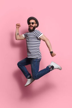 Şık adam pembe üzerinde atlama