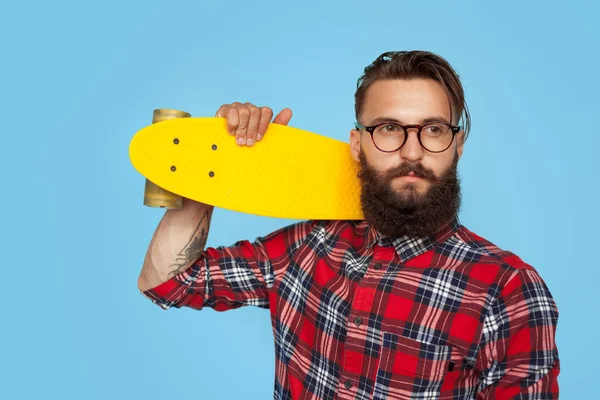 Hipster confiante com longboard amarelo — Fotografia de Stock