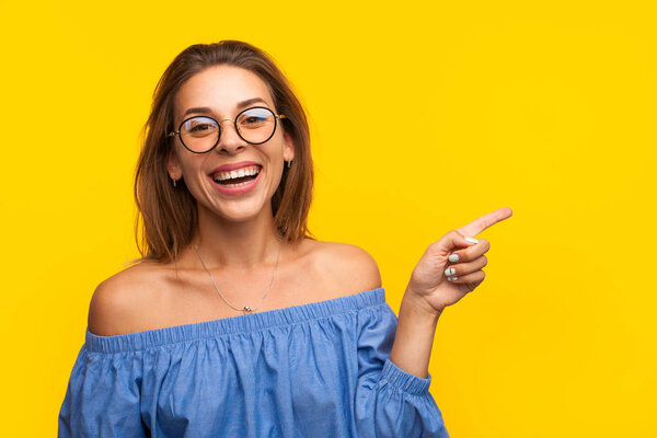 Cheerful model pointing away