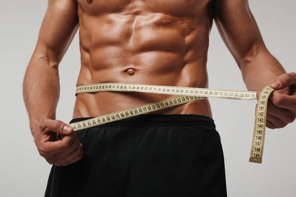 Man measuring abs with tape — Stock Photo, Image