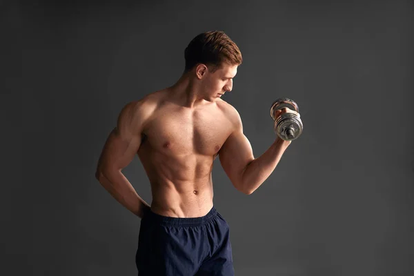 Handsome sportsman training bicep in studio — Stock Photo, Image