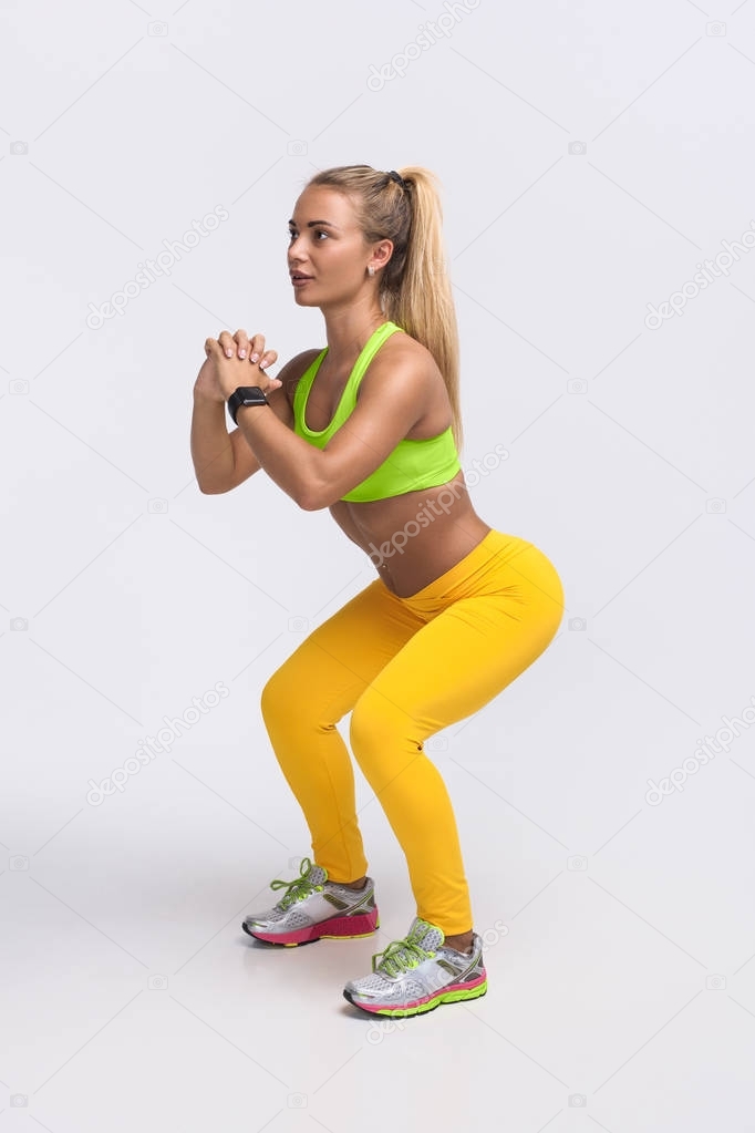 Woman squatting on white
