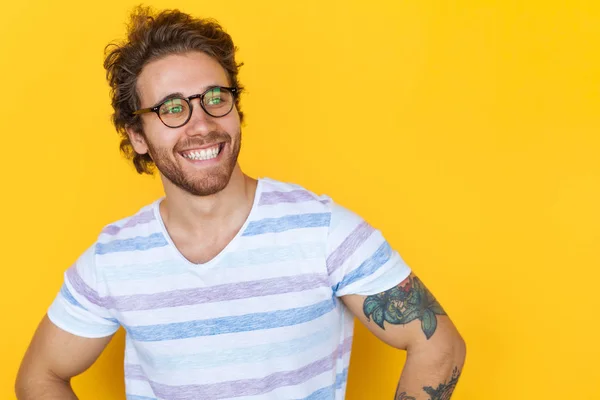 Smiling handsome man posing on yellow — Stock Photo, Image