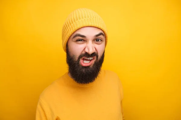 Grijnzende man in het gele kijken naar camera — Stockfoto