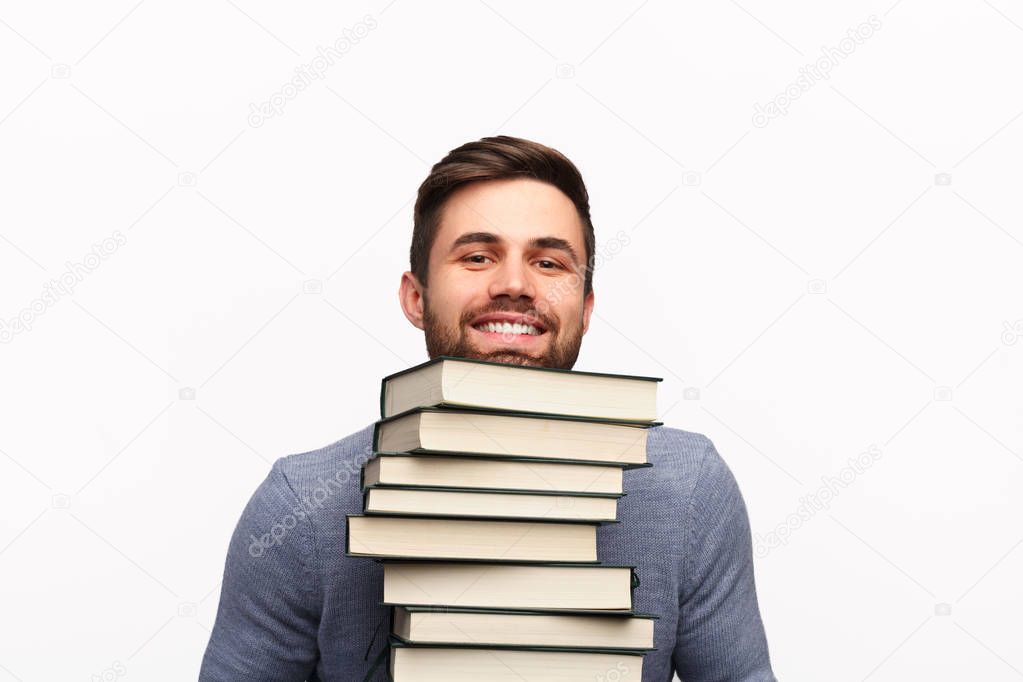 Smart student with stack of books