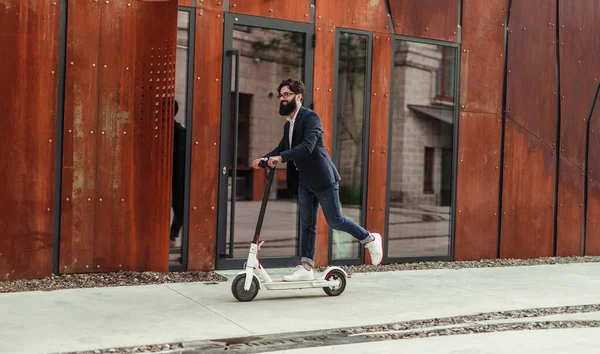 Glad hipster ridning elektrisk skoter — Stockfoto