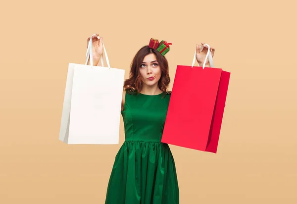 Thoughtful female choosing between gifts — Stock Photo, Image