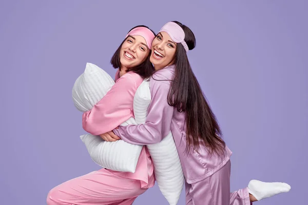 Delighted best friends hugging during slumber party — ストック写真