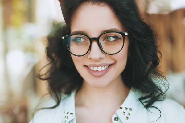 Charming woman in big round glasses looking away — ストック写真